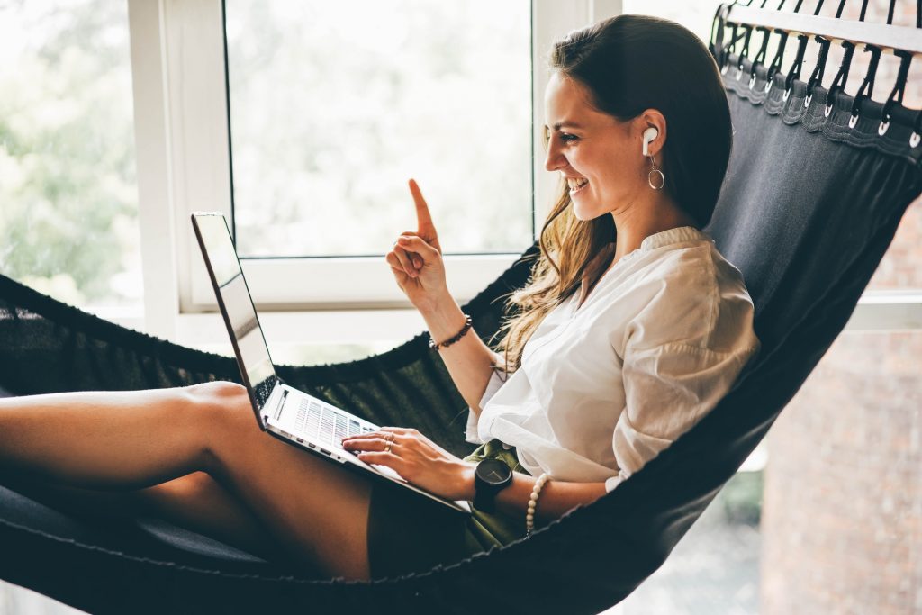 Businesswoman working on a hammock. Freelancer and her workspace.